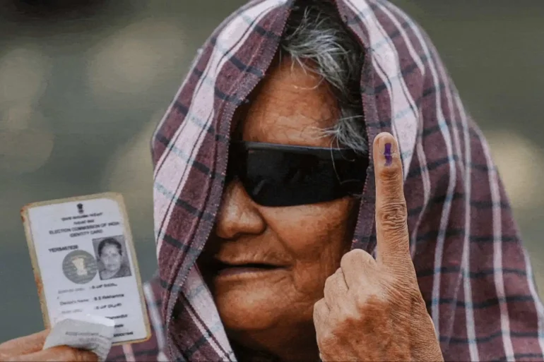 Women voters wait to cast their votes for the phase 2 of Lok Sabha elections