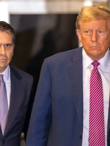 Former President Donald Trump walks with lawyer Todd Blanche at Manhattan Criminal Court in New York City on Friday.